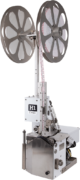Bedford H1 high speed bag closure machine with two round reels of bag closure clips.