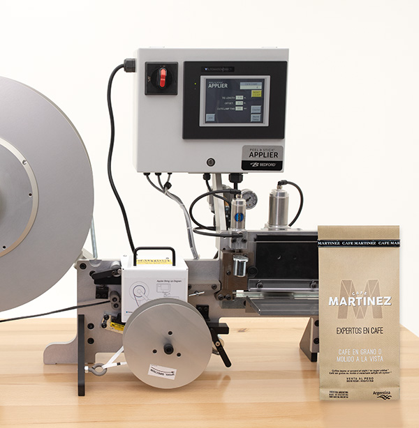 Machine that applies Peel and Stick bag closures horizontally.