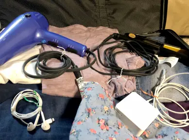 Twist ties keep corded items organized in a suitcase