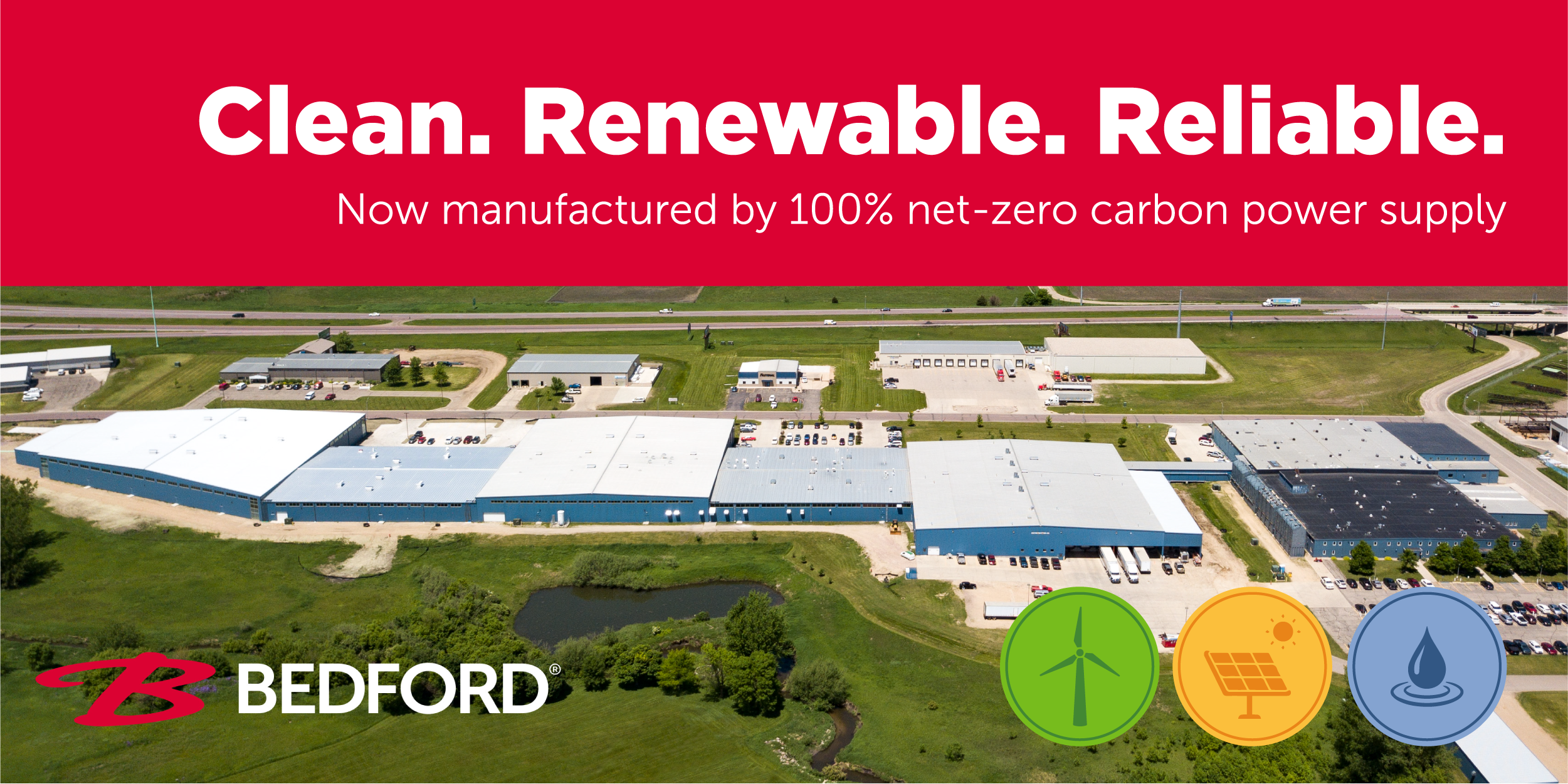 Aerial view of Bedford Industries’ manufacturing facility with "Clean. Renewable. Reliable. Now manufactured by 100% net-zero carbon power supply."