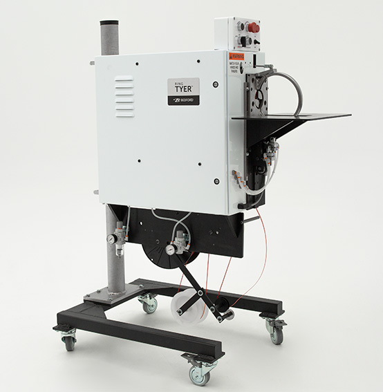 white machine that applies twist ties to secure hoses and cords.