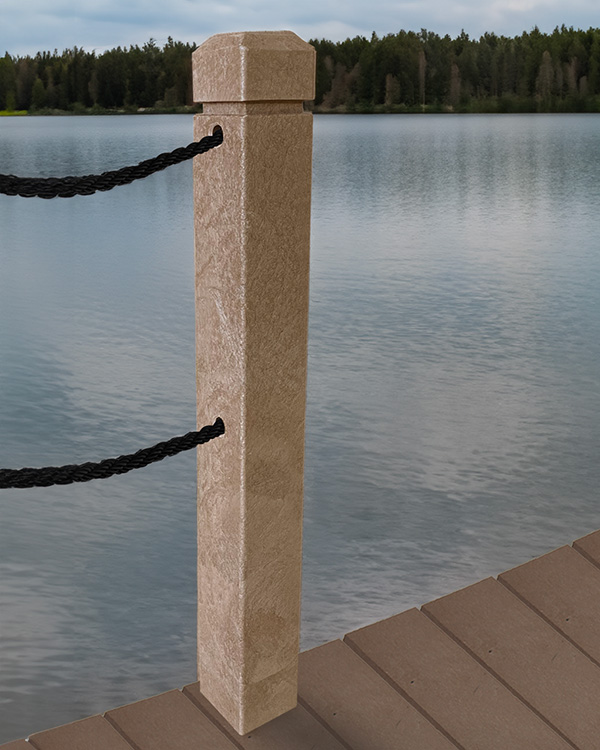 Tan bollard on a wooden dock with black ropes, overlooking a calm lake and forested shoreline.