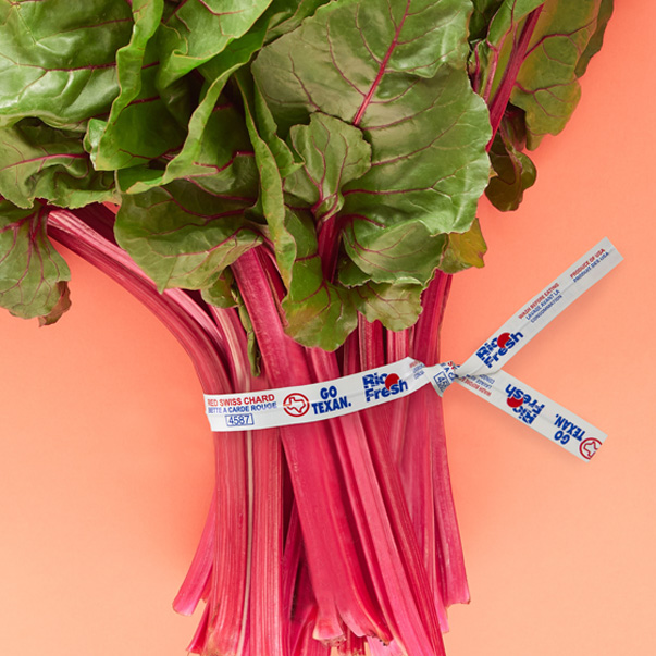A produce twist tie labeling a bunch of Rio Fresh brand red swiss chard.