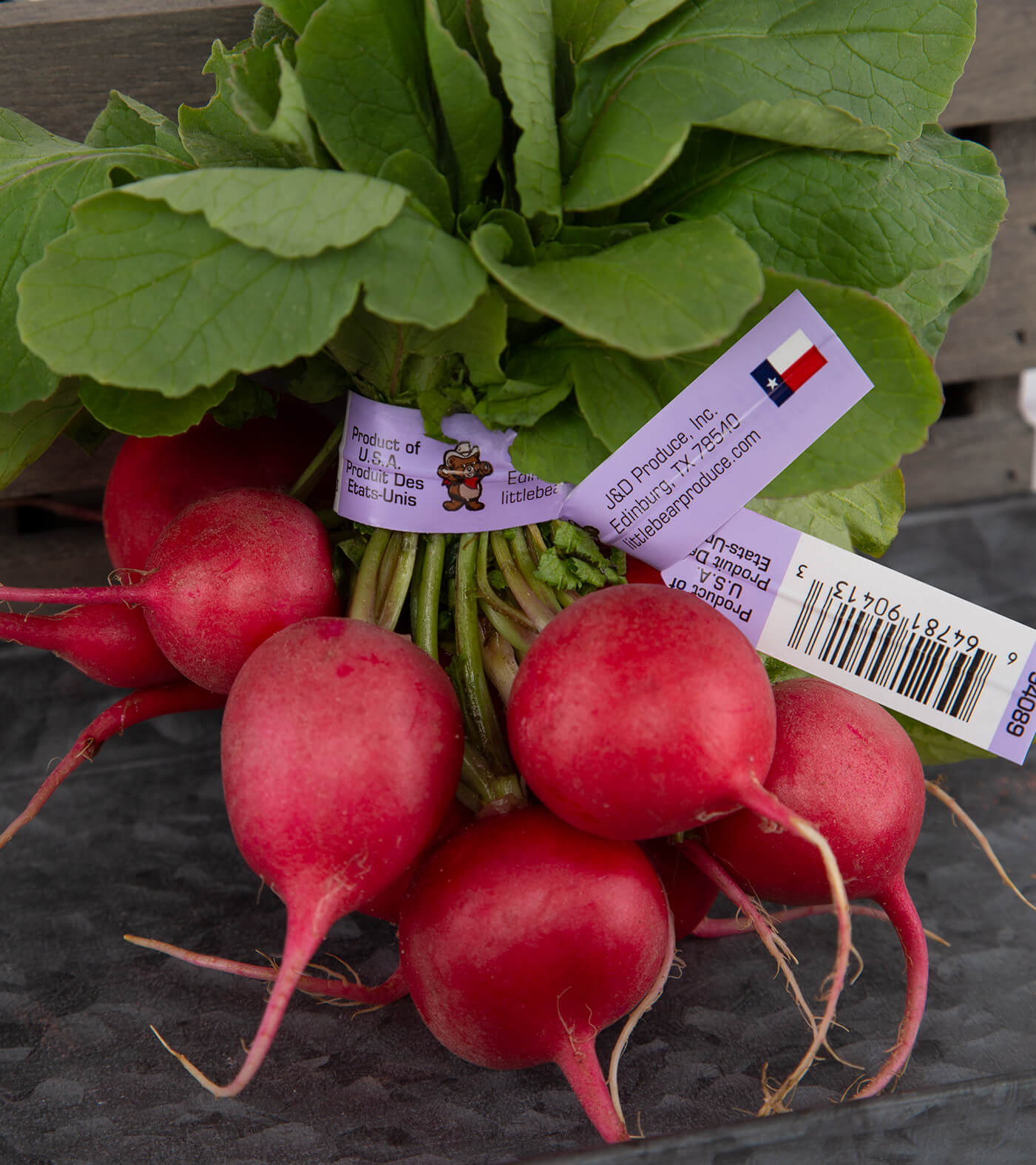 wire and plastic label twist tie around red radishes
