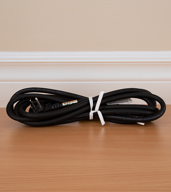 White bundling tie applied to a black electrical cord.