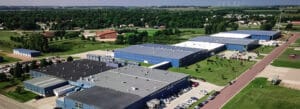 A slow-moving drone video of Bedford Industries’ blue manufacturing buildings.