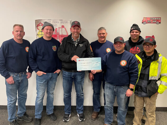 Bedford Industries' employees accept a check on behalf of the volunteer fire department