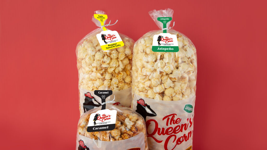 3 bags of gourmet popcorn closed with a twist tie and bag tag identifying the flavors: jalapeño, caramel, and sweet & salty